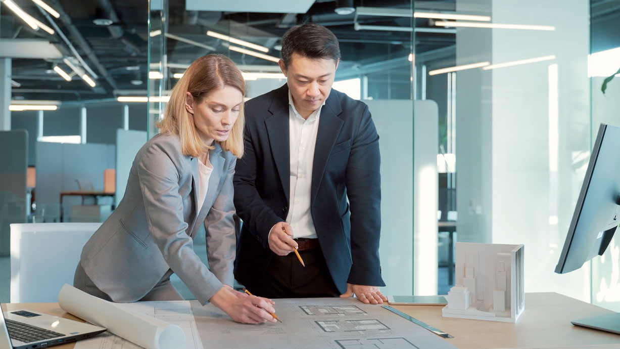 associates review a floor plan